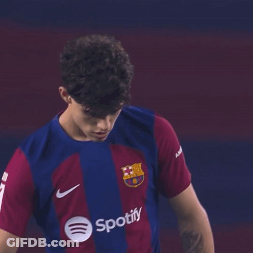 A Young Man Wearing A Spotify Shirt Is Looking At The Camera GIF