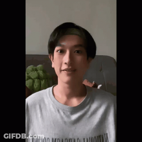 A Young Man Wearing A T-Shirt That Says ' Hollywood Mountain ' On It GIF