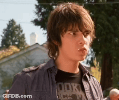 A Young Man Wearing A T-Shirt That Says Rock On It GIF