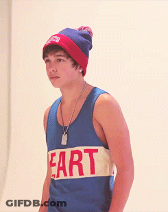 A Young Man Wearing A Tank Top That Says Fart On It GIF