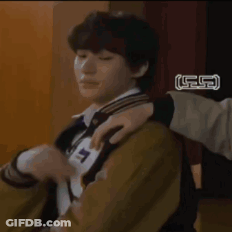 A Young Man Wearing A Varsity Jacket With The Letter R On It Is Sitting In A Chair . GIF