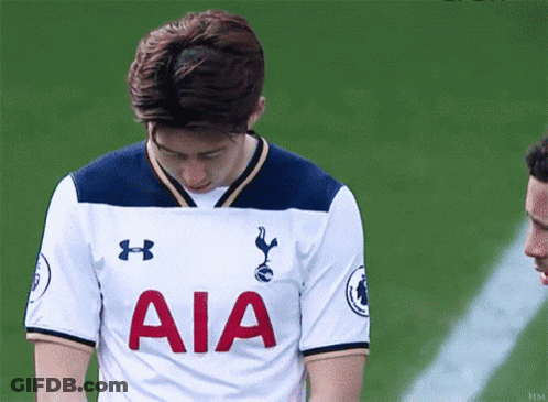A Young Man Wearing A White Aia Jersey Looks Down GIF
