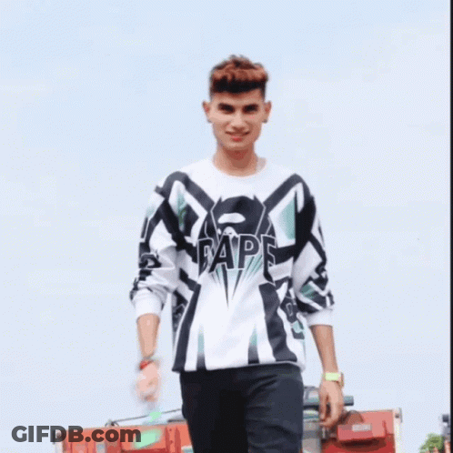 A Young Man Wearing A White And Black Shirt With The Word Ape On The Front GIF