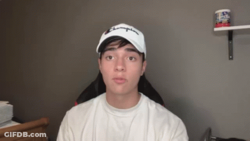 A Young Man Wearing A White Champion Hat GIF