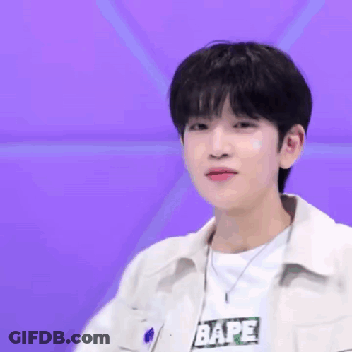 A Young Man Wearing A White Jacket And A White Shirt With The Word Bape On It GIF