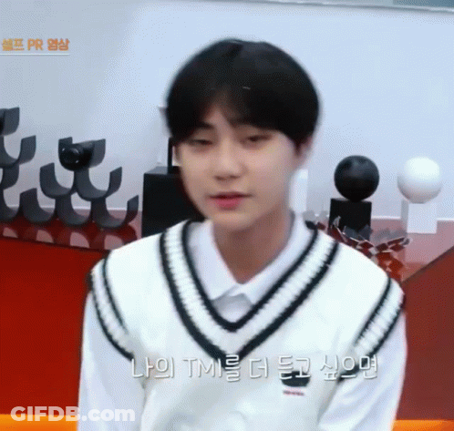 A Young Man Wearing A White Shirt And A Black And White Vest Is Talking To Someone In Korean GIF