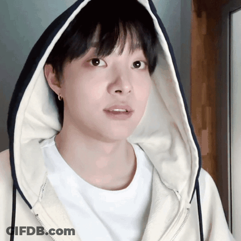 A Young Man Wearing A White Shirt And A Hooded Jacket GIF