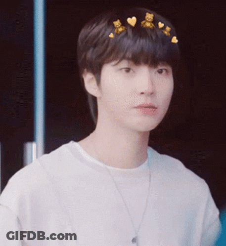 A Young Man Wearing A White Shirt And A Necklace With Teddy Bears On His Hair . GIF