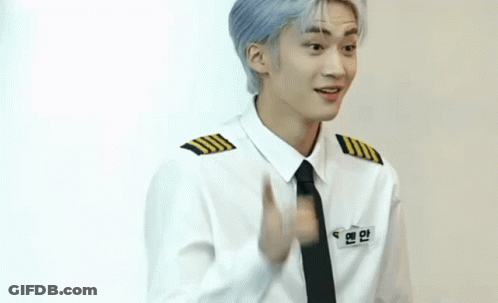 A Young Man Wearing A White Shirt And Black Tie Is Pointing GIF