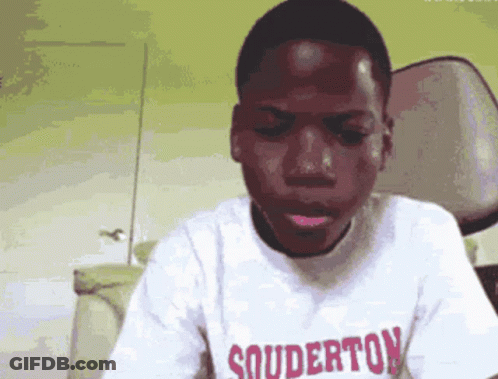 A Young Man Wearing A White Shirt That Says Souderton GIF