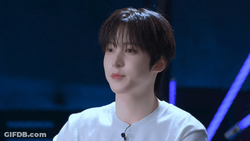 A Young Man Wearing A White Shirt With A Microphone Attached To It GIF