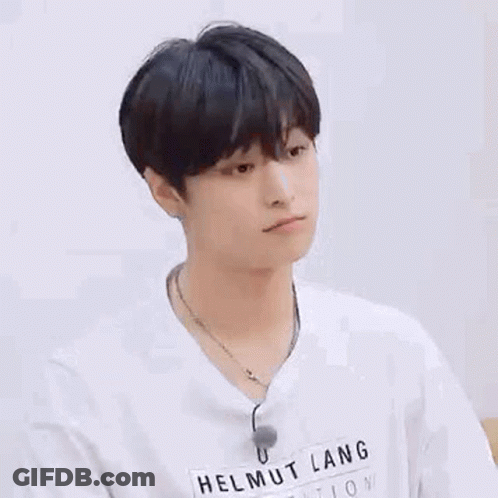 A Young Man Wearing A White T-Shirt And A Necklace . GIF