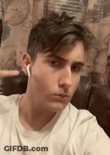 A Young Man Wearing A White T-Shirt And White Earbuds Takes A Selfie GIF
