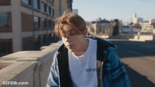 A Young Man Wearing A White T-Shirt That Says Ibnao GIF
