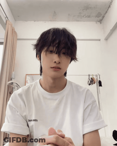 A Young Man Wearing A White T-Shirt That Says ' Iceberg ' On The Sleeve GIF
