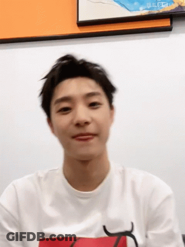 A Young Man Wearing A White T-Shirt With A Red Letter K On It GIF