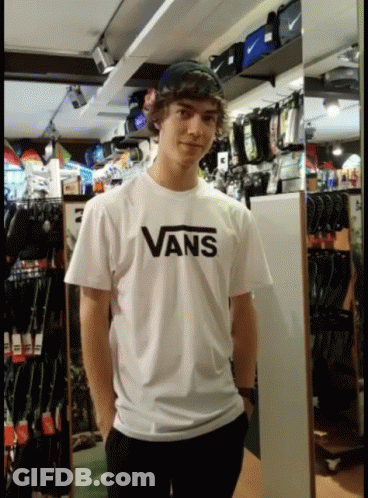 A Young Man Wearing A White Vans Shirt GIF