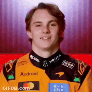 A Young Man Wearing A Yellow And Black Racing Jacket With The Word Android On It . GIF