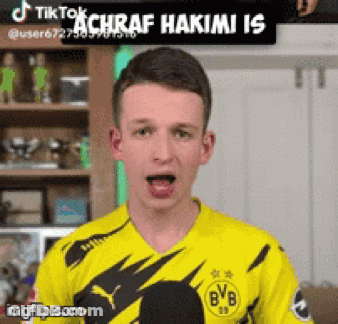 A Young Man Wearing A Yellow Bvb Jersey GIF