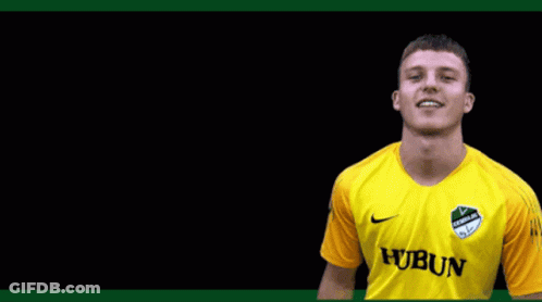 A Young Man Wearing A Yellow Jersey With The Word Hubun On It GIF