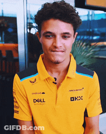 A Young Man Wearing A Yellow Polo Shirt With Dell Written On It GIF