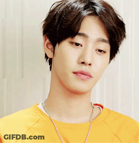 A Young Man Wearing A Yellow Shirt And A Necklace GIF