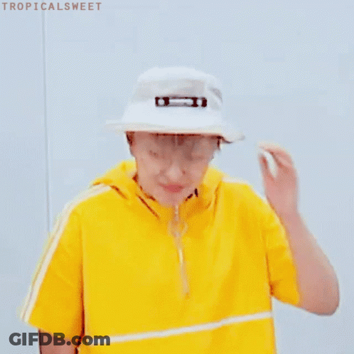 A Young Man Wearing A Yellow Shirt And A White Hat . GIF