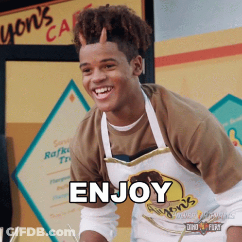 A Young Man Wearing An Apron That Says Enjoy On It GIF