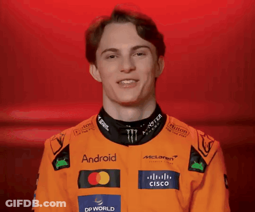 A Young Man Wearing An Orange Jacket With Logos For Android And Cisco On It GIF