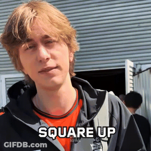 A Young Man Wearing An Orange Shirt And A Black Jacket With The Words Square Up Above Him GIF