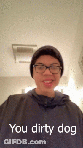 A Young Man Wearing Glasses And A Beanie Says " You Dirty Dog " GIF