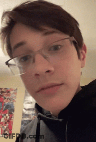 A Young Man Wearing Glasses And A Black Hoodie GIF