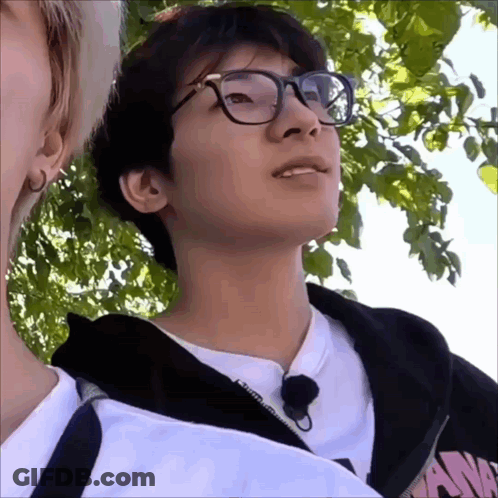 A Young Man Wearing Glasses And A Black Hoodie With The Word N On It GIF