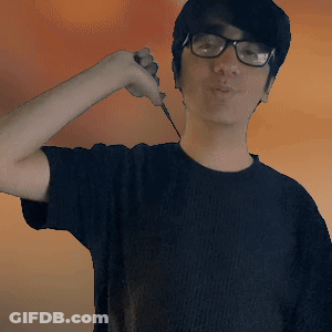 A Young Man Wearing Glasses And A Black Shirt Is Holding A Knife GIF