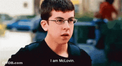 A Young Man Wearing Glasses And A Black Shirt Says I Am Mclovin GIF