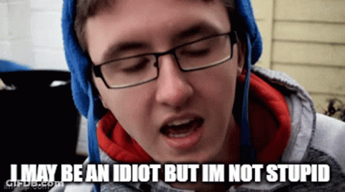 A Young Man Wearing Glasses And A Blue Hat Is Saying I May Be An Idiot But Im Not Stupid GIF