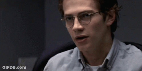A Young Man Wearing Glasses And A Light Blue Shirt GIF