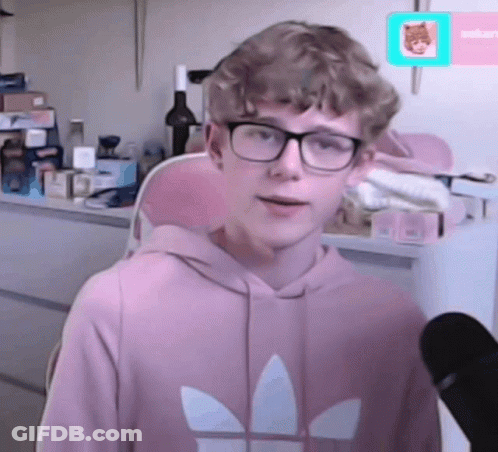 A Young Man Wearing Glasses And A Pink Adidas Sweatshirt GIF