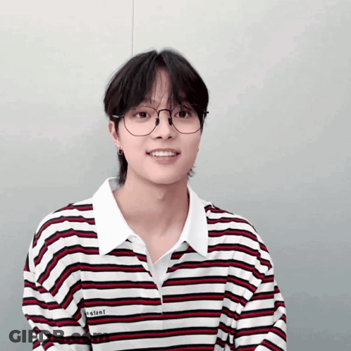 A Young Man Wearing Glasses And A Striped Shirt With The Word Instant On It GIF