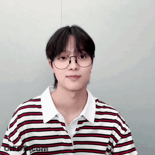 A Young Man Wearing Glasses And A Striped Shirt With The Word Vincent On The Front GIF