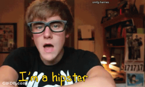 A Young Man Wearing Glasses And A T-Shirt That Says I 'M A Hipster GIF