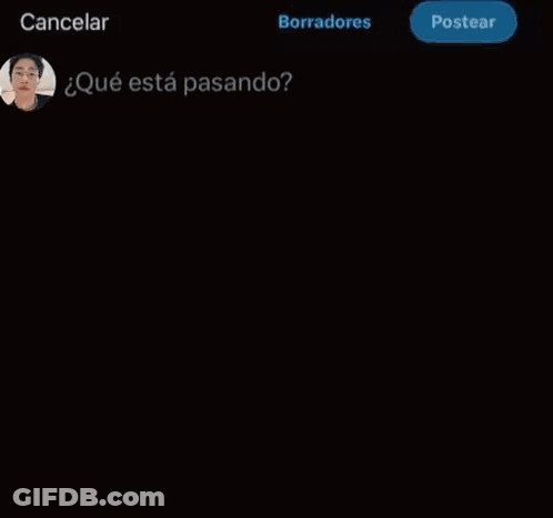 A Young Man Wearing Glasses And A White Jacket Is Looking At A Cell Phone . GIF