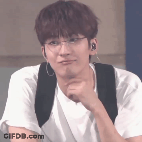 A Young Man Wearing Glasses And Ear Buds Is Making A Funny Face GIF