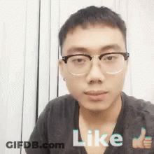 A Young Man Wearing Glasses Is Giving A Thumbs Up Sign . GIF