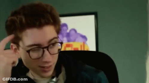 A Young Man Wearing Glasses Is Sitting In A Chair In Front Of A Computer Screen . GIF