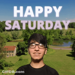 A Young Man Wearing Glasses Is Standing In Front Of A Happy Saturday Sign GIF
