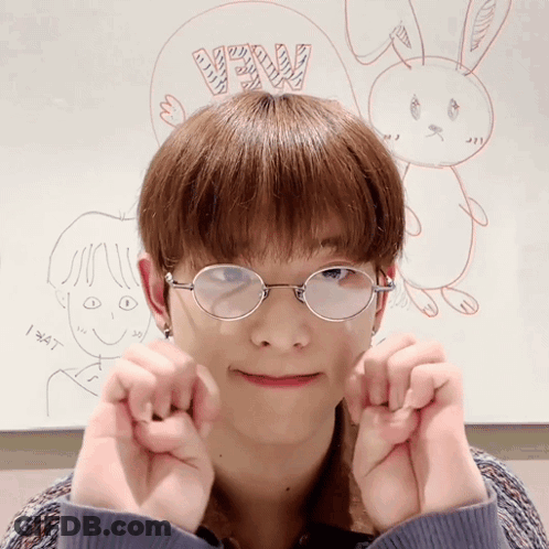 A Young Man Wearing Glasses Making A Heart With His Hands GIF