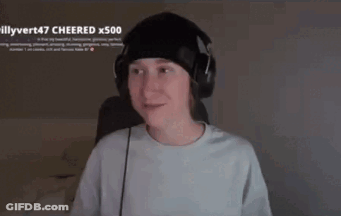 A Young Man Wearing Headphones And A Beanie Is Sitting In Front Of A Computer Screen . GIF