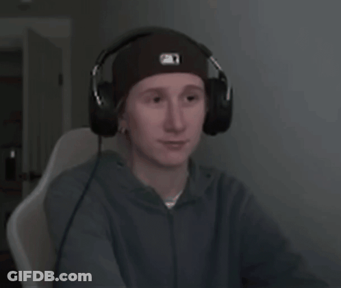 A Young Man Wearing Headphones And A Beanie With The Letter O On It GIF