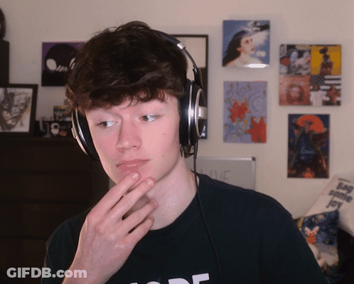A Young Man Wearing Headphones And A Black Shirt That Says Mode GIF